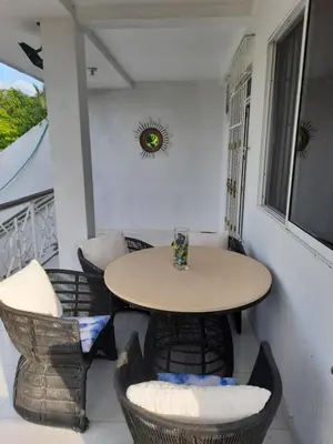 a small table and chairs on a balcony at VILLA MARIA in Turbaco