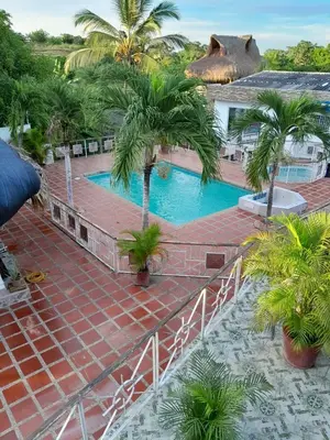a resort with a swimming pool and palm trees at VILLA MARIA in Turbaco