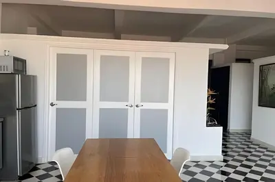 a kitchen with a wooden table and a refrigerator at 704 Puesta de sol apto en Cartagena in Cartagena de Indias