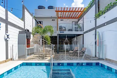 a house with a swimming pool and a house at COMFORT+TRANQUILIDAD=ROMÁNTICO APARTAESTUDIO CON PISCINA #6 in Santa Marta