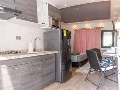 a kitchen and dining room with a table and chairs at COMFORT+TRANQUILIDAD=ROMÁNTICO APARTAESTUDIO CON PISCINA #6 in Santa Marta