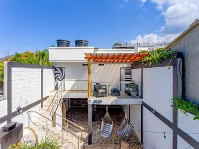 a house with a staircase leading up to a balcony at COMFORT+TRANQUILIDAD=ROMÁNTICO APARTAESTUDIO CON PISCINA #6 in Santa Marta