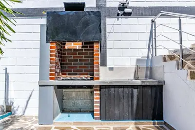 a brick oven on the side of a house at COMFORT+TRANQUILIDAD=ROMÁNTICO APARTAESTUDIO CON PISCINA #6 in Santa Marta