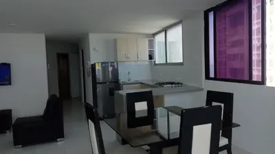 a kitchen with a refrigerator and a table and chairs at Apartamento 3 Carabelas Cartagena Piso 16 in Cartagena de Indias
