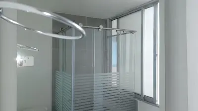 a glass shower in a bathroom with a window at Apartamento 3 Carabelas Cartagena Piso 16 in Cartagena de Indias