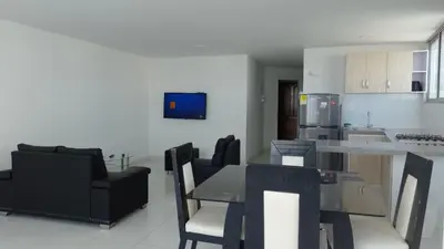 a kitchen and living room with a table and chairs at Apartamento 3 Carabelas Cartagena Piso 16 in Cartagena de Indias