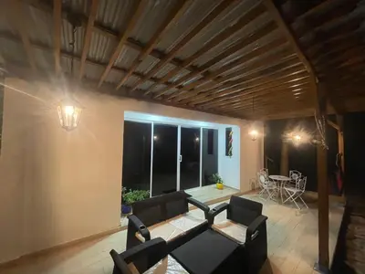 a living room with a couch and a table at CABAÑA EN ISLA FRENTE A CARTAGENA in Cartagena de Indias