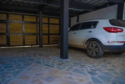 a white car is parked in a garage at Confort+Relax= Romántico ApartaEstudio + Piscina + Parqueadero in Santa Marta
