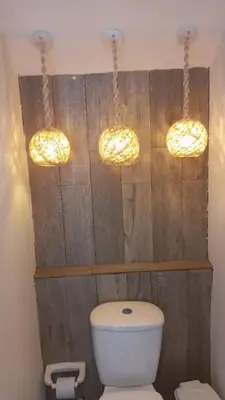 a bathroom with three lights above a toilet at Confort+Relax= Romántico ApartaEstudio + Piscina + Parqueadero in Santa Marta