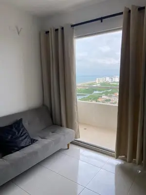 a couch in a room with a large window at Taller del artista II in Cartagena de Indias