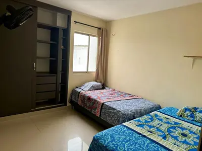 a bedroom with two beds and a window at Apartamento en el epicentro del Carnaval in Barranquilla