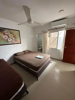 a bedroom with a large bed and a window at APARTAMENTO in Cartagena de Indias