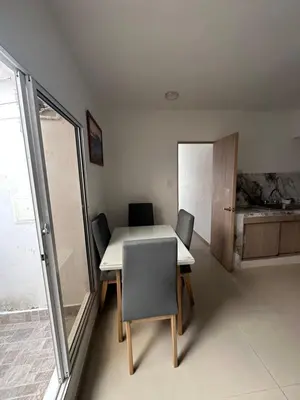 a table and chairs in a room with a window at APARTAMENTO in Cartagena de Indias