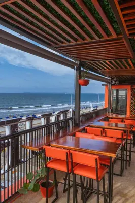 a row of tables and chairs on a balcony with the beach at King's Apartments 302 in Cartagena de Indias