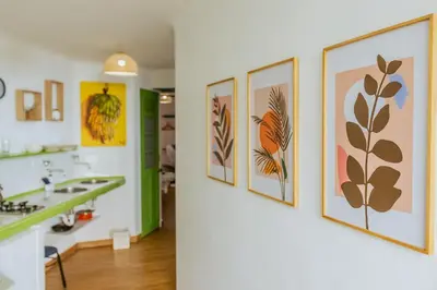 a bathroom with a row of paintings on the wall at King's Apartments 302 in Cartagena de Indias