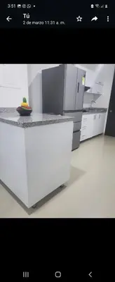 a kitchen with a counter with a bowl of fruit on it at Apartment by the sea in Puerto Colombia