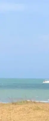 a beach with the ocean in the background at Apartment by the sea in Puerto Colombia