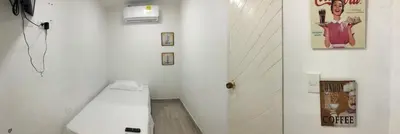 a white bathroom with a toilet and a sink at Martinica Hostel in Cartagena de Indias