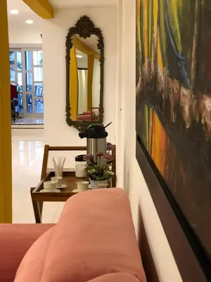 a living room with a couch and a painting on the wall at Martinica Hostel in Cartagena de Indias