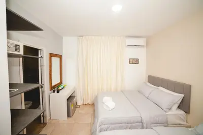 a small bedroom with a bed and a mirror at Abel Boutique House in Cartagena de Indias