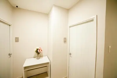 a white room with a vase of flowers on a table at Abel Boutique House in Cartagena de Indias