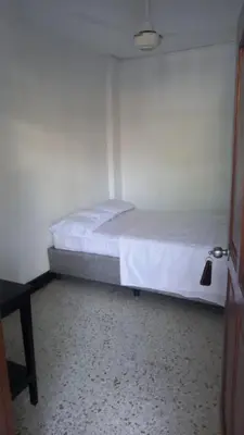 a bedroom with a bed in a room at HOTEL LOS GUADUALES in Barranquilla