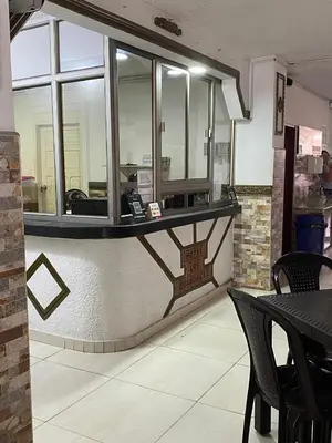a restaurant with a counter with a phone on it at HOTEL LOS GUADUALES in Barranquilla