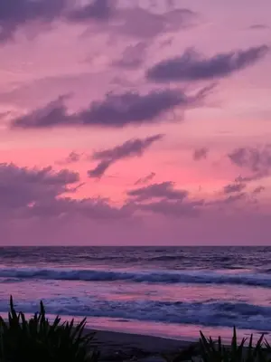 a sunset over a beach with the ocean at Arcoiris EcoHotel in San Bernardo del Viento