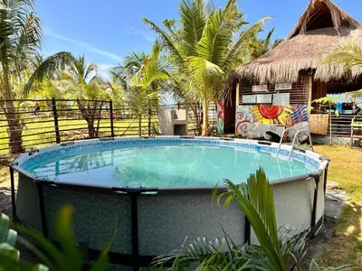 a large swimming pool in front of a resort at Arcoiris EcoHotel in San Bernardo del Viento