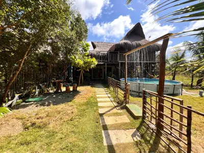 a house with a swimming pool and a fence at Arcoiris EcoHotel in San Bernardo del Viento