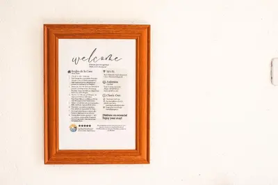a picture of a menu hanging on a wall at Villa Nuevo Amanecer Santa Verónica in Santa Veronica