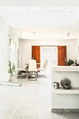 a living room with white walls and a glass wall at Villa Nuevo Amanecer Santa Verónica in Santa Veronica