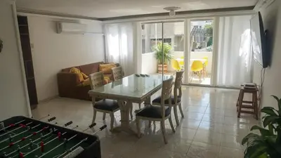 a living room with a glass table and chairs at Azul de Bocagrande in Cartagena de Indias
