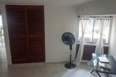 a room with a fan and a window at Azul de Bocagrande in Cartagena de Indias