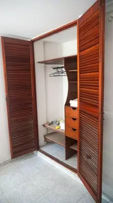 a room with a closet with wooden doors at Azul de Bocagrande in Cartagena de Indias