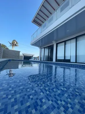 a swimming pool in front of a house at Casita Madrigal in Santa Veronica