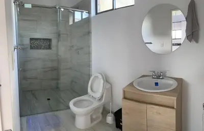 a bathroom with a shower and a toilet and a sink at Casita Madrigal in Santa Veronica