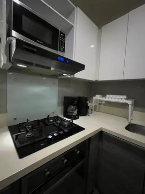 a kitchen with a stove and a microwave at Morros Cartagena junto al Hotel las Américas Edificio Spiaggia salida a playa in Cartagena de Indias