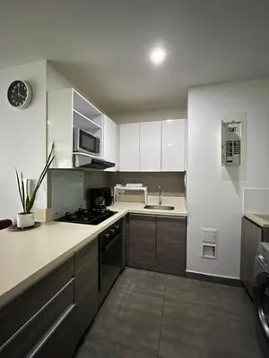 a kitchen with white cabinets and a stove top oven at Morros Cartagena junto al Hotel las Américas Edificio Spiaggia salida a playa in Cartagena de Indias