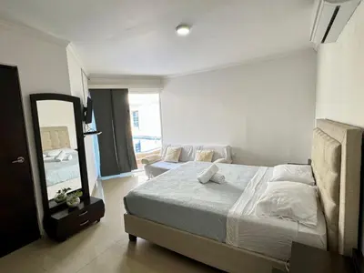 a bedroom with a large bed and a mirror at Casa palma Cartagena de Indias, Colombia in Cartagena de Indias