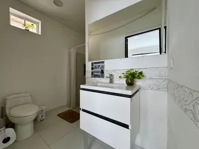 a white bathroom with a sink and a toilet at Casa palma Cartagena de Indias, Colombia in Cartagena de Indias