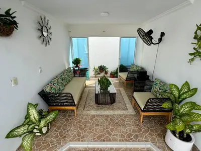 a living room with couches and potted plants at Casa palma Cartagena de Indias, Colombia in Cartagena de Indias