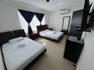 a bedroom with two beds and a flat screen tv at Casa palma Cartagena de Indias, Colombia in Cartagena de Indias