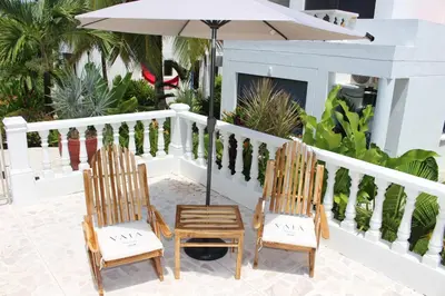 two chairs and an umbrella on a balcony at VAIA HOTELES in Coveñas