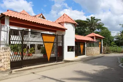a house with a gate on a street at VAIA HOTELES in Coveñas