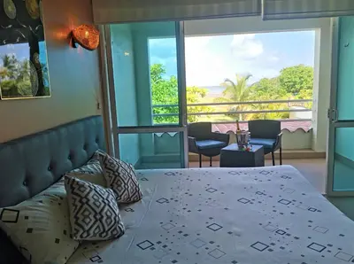 a bedroom with a bed with a view of the ocean at Beach Villa Sol & Mar Cartagena, beachfront & private pool in Cartagena de Indias