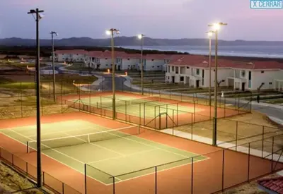 two tennis courts with lights on them in a parking lot at Beach Villa Sol & Mar Cartagena, beachfront & private pool in Cartagena de Indias