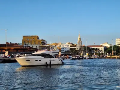a white boat is docked in a harbor at Beach Villa Sol & Mar Cartagena, beachfront & private pool in Cartagena de Indias