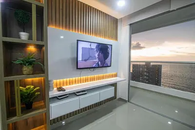 a living room with a television on a wall at La mejor vista al mar y ubicacion en Cartagena in Cartagena de Indias
