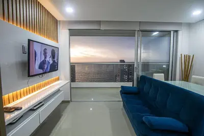 a living room with a blue couch and a large window at La mejor vista al mar y ubicacion en Cartagena in Cartagena de Indias